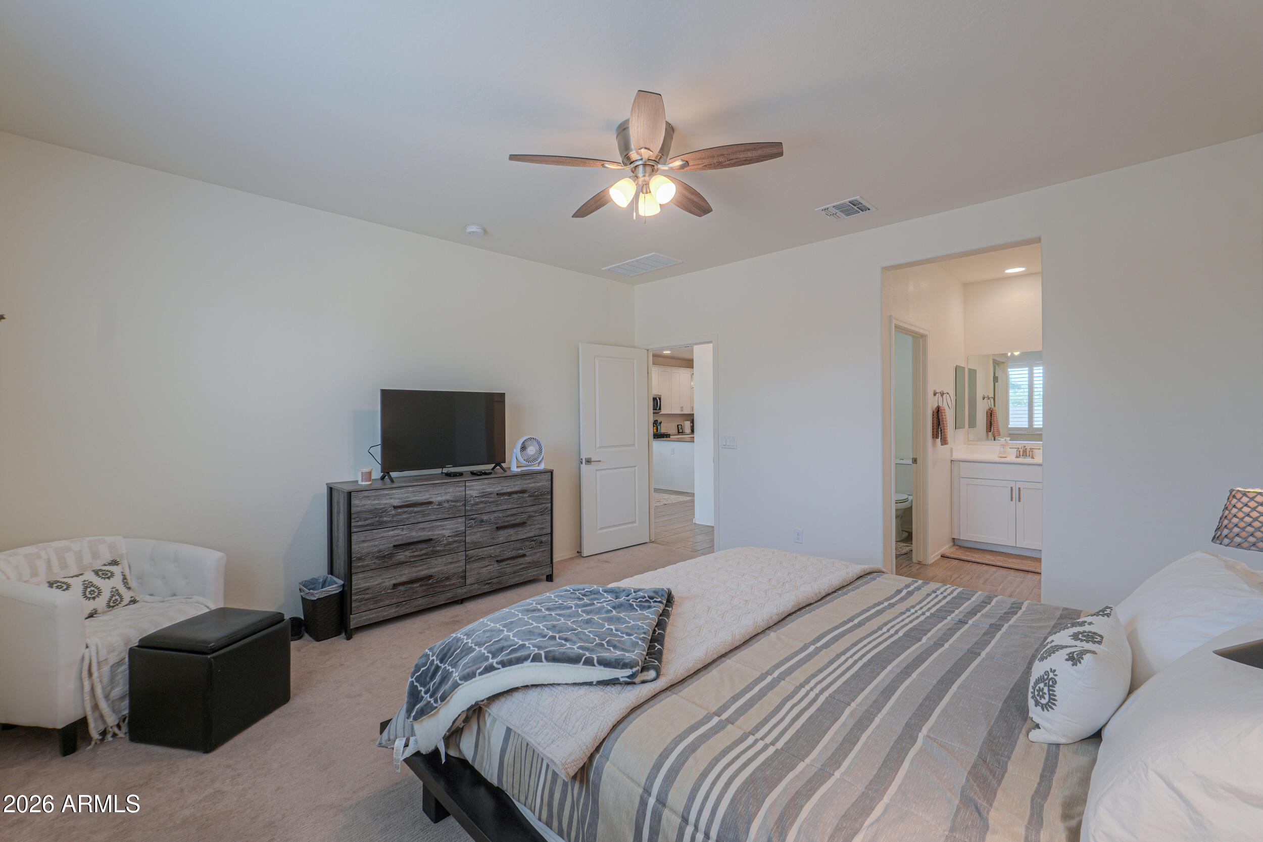 42085 West Cribbage Road Maricopa, AZ 85138 - Photo 23 of 35 a bedroom with a bed and a flat screen tv