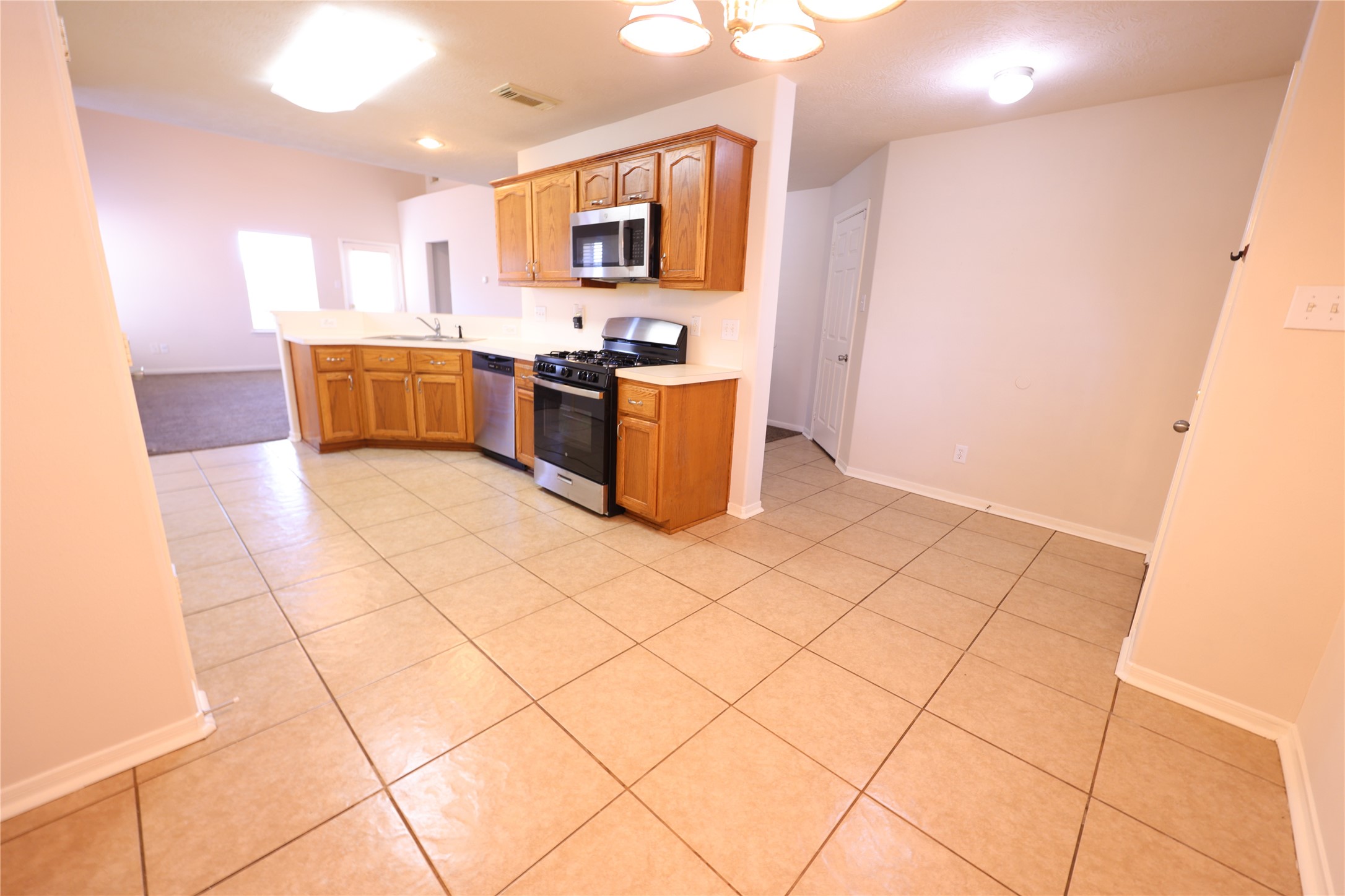 1007 Harrisburg Court Rosenberg, TX 77471 - Photo 13 of 24 a kitchen with stainless steel appliances kitchen island granite countertop a sink and cabinets