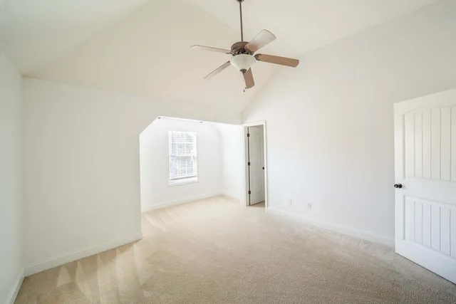 a view of a room with a ceiling fan