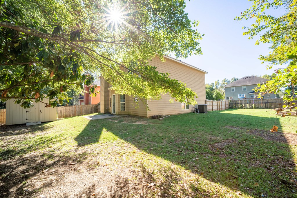5151 Mccaghren Drive Columbus, GA 31909 - Photo 15 of 15 a view of a yard with plants and a tree