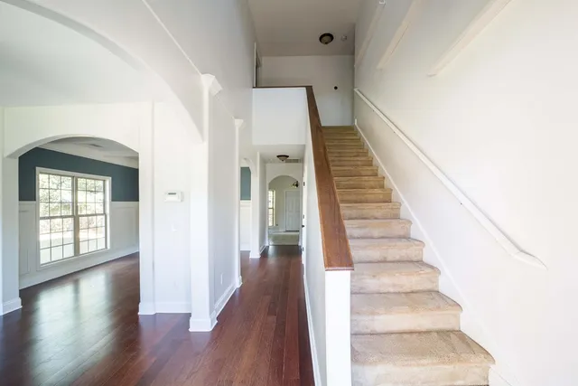 a view of entryway and hall with wooden floor