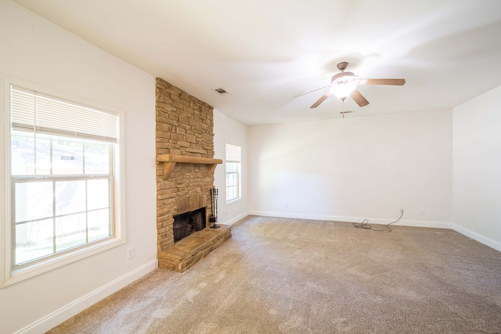 5151 Mccaghren Drive Columbus, GA 31909 - Photo 7 of 15 a view of an empty room with a fireplace and a window