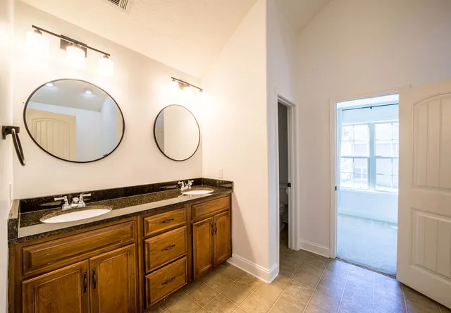 a bathroom with a mirror and a sink