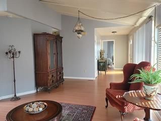 a view of a livingroom with furniture and a window