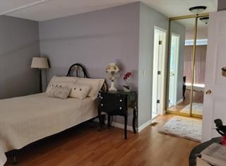 a bedroom with a bed and a mirror