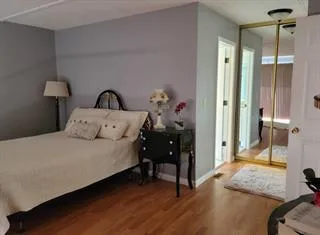 a bedroom with a bed and a mirror