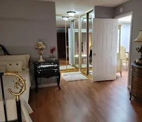 a view of hall way with furniture and wooden floor