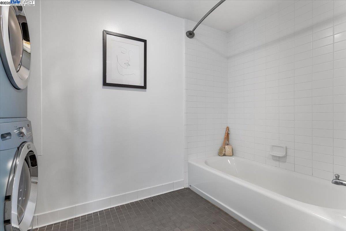 226 2nd Street Oakland, CA 94607 - Photo 13 of 28 a white bath tub sitting next to a white sink and vanity