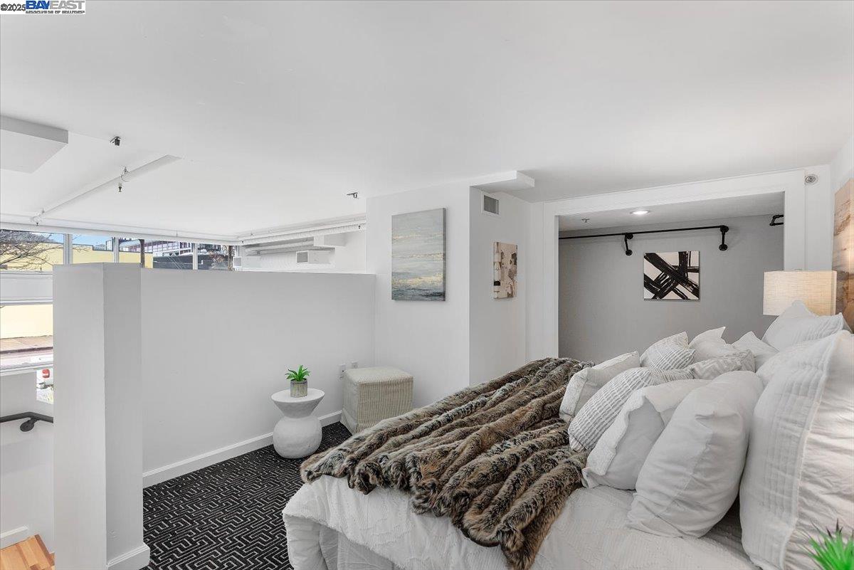 226 2nd Street Oakland, CA 94607 - Photo 17 of 28 a bed room with a bed and a couch