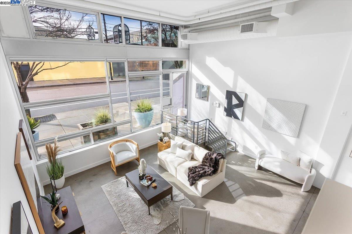 226 2nd Street Oakland, CA 94607 - Photo 21 of 28 a living room with furniture and a floor to ceiling window