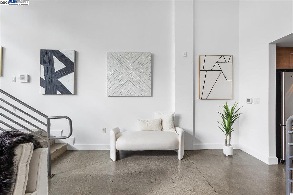 226 2nd Street Oakland, CA 94607 - Photo 3 of 28 a living room with furniture a potted plant and a painting on the wall