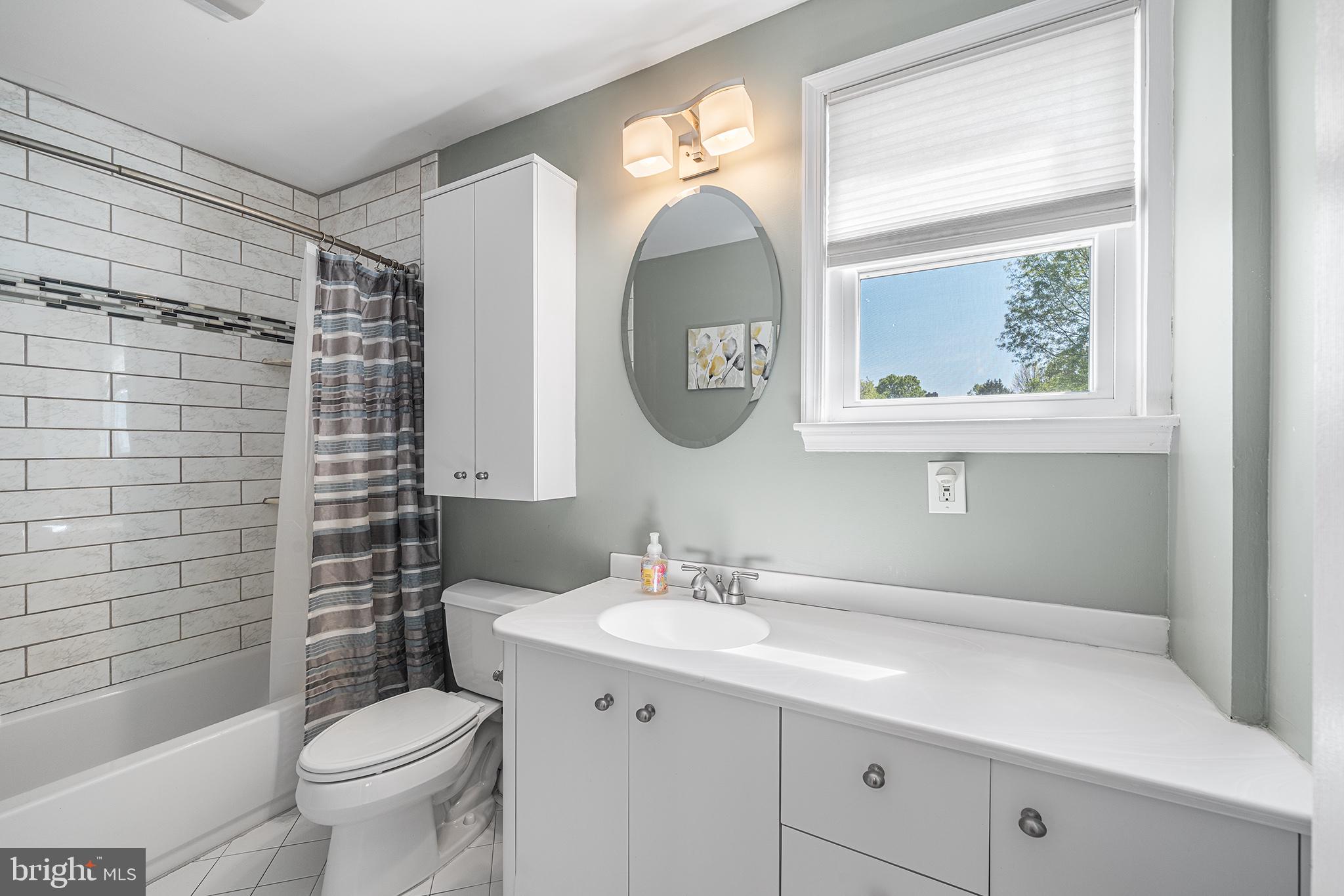 702 Brookhaven Road Wallingford, PA 19086 - Photo 21 of 31 a bathroom with a toilet a sink a mirror and a shower