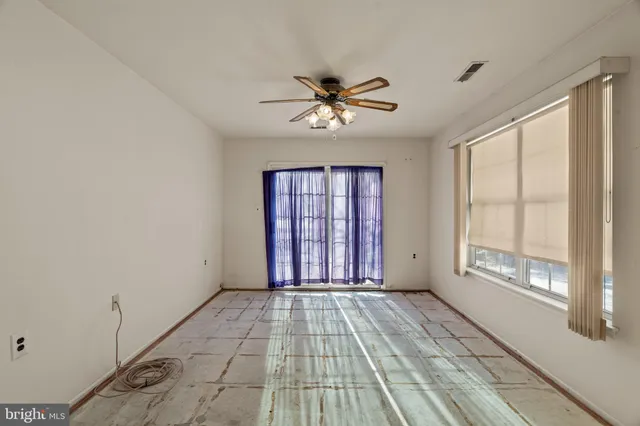 a view of a livingroom with a ceiling fan and window