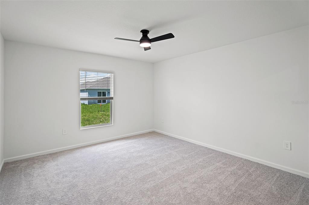 1993 Sarah Street Lake Wales, FL 33859 - Photo 10 of 31 an empty room with windows and ceiling fan