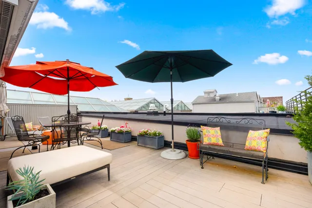 an outdoor space with furniture and umbrella