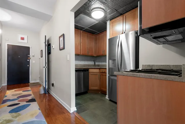 a kitchen with stainless steel appliances a refrigerator and a stove