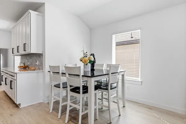 a view of a dining room with furniture and wooden floor