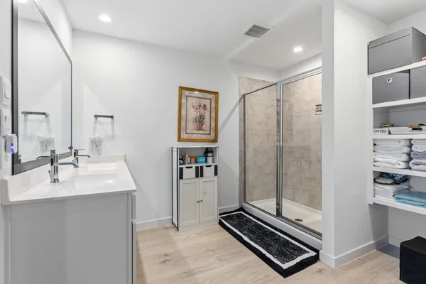 a bathroom with a sink a mirror and a shower