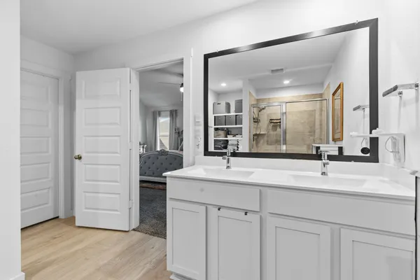 a bathroom with a double vanity sink and a mirror