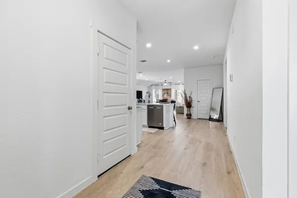a view of a kitchen with furniture and an empty room