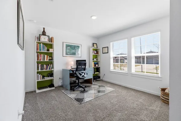 a living room with furniture cabinets and window