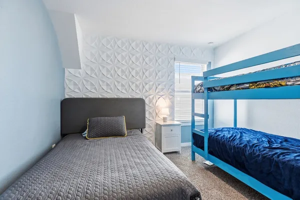 a bedroom with a bed and a fireplace