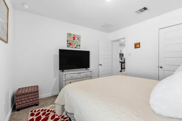 a bedroom with a bed and a flat screen tv