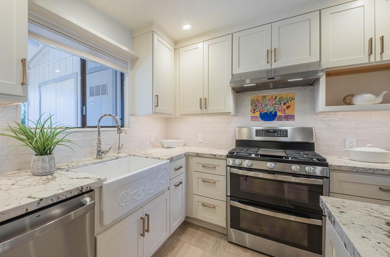 250 Forest Ridge Road, Unit 27 Monterey, CA 93940 - Photo 15 of 38 a kitchen with granite countertop a sink stainless steel appliances and cabinets