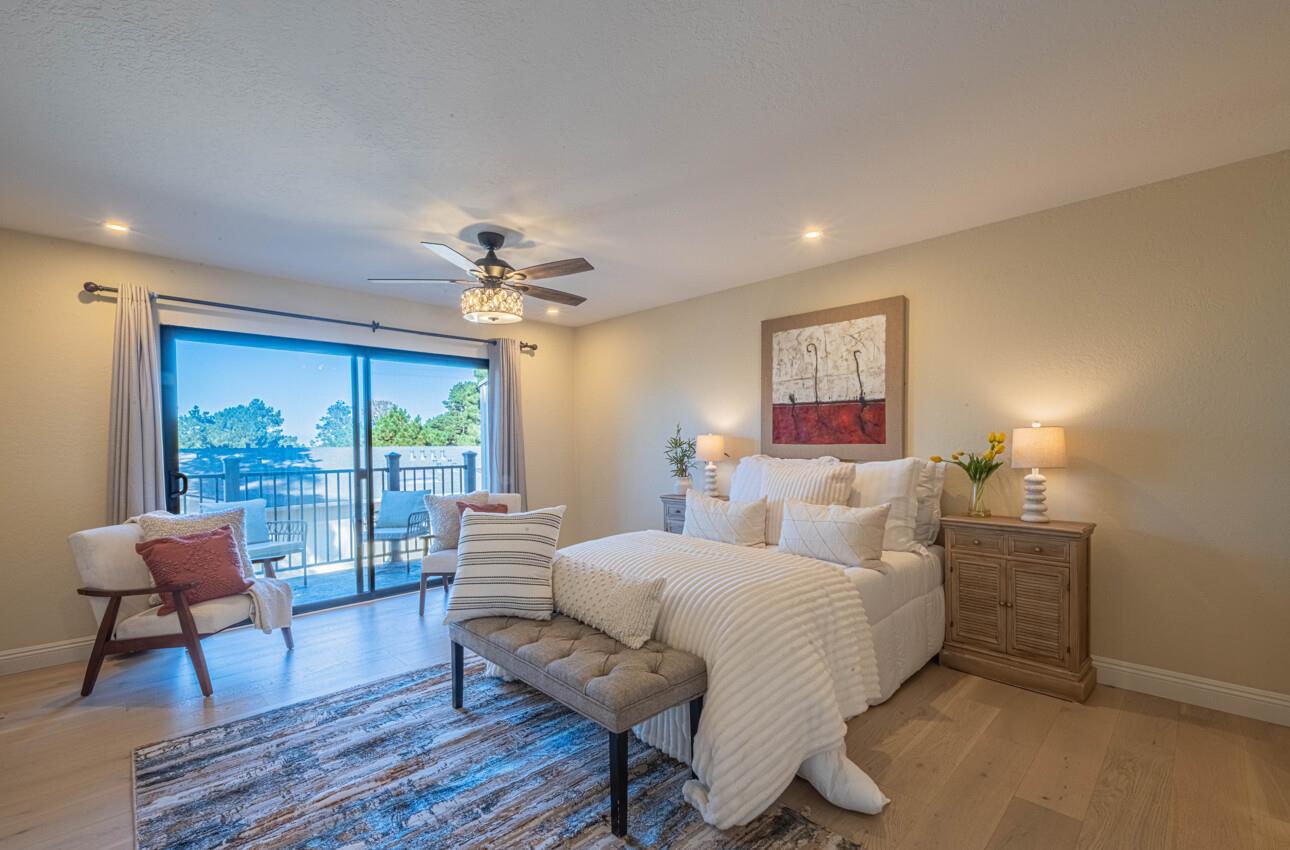 250 Forest Ridge Road, Unit 27 Monterey, CA 93940 - Photo 19 of 38 a bedroom with a bed and a large window