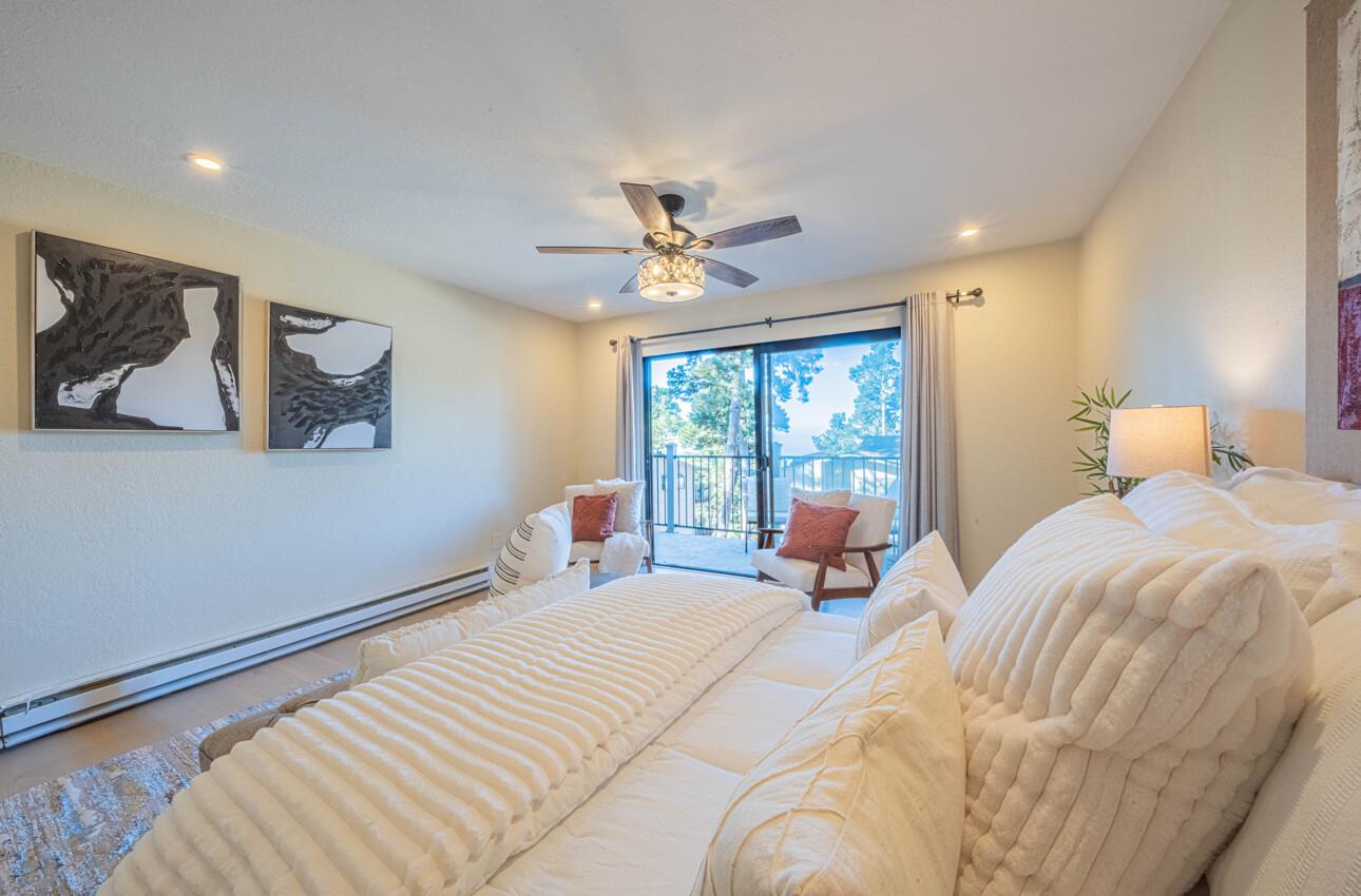 250 Forest Ridge Road, Unit 27 Monterey, CA 93940 - Photo 20 of 38 a bedroom with a large bed and a large window