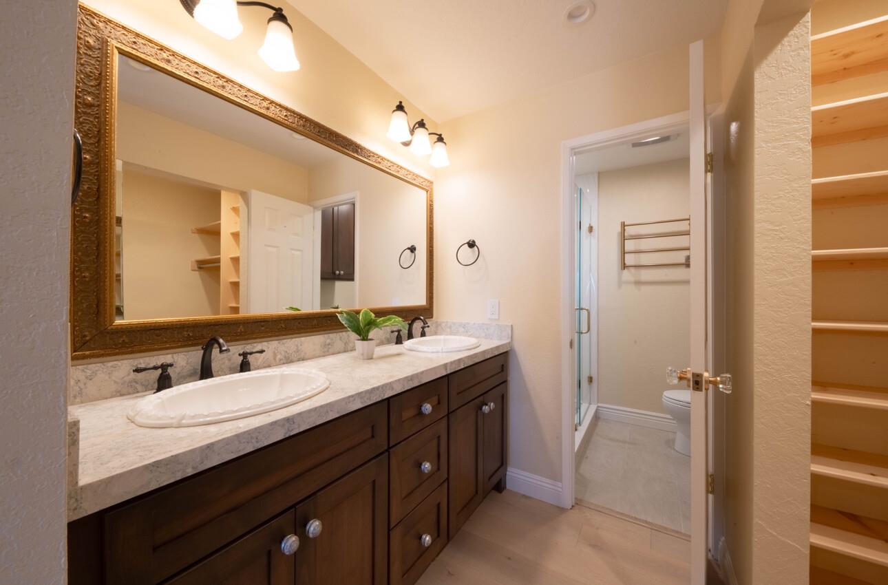 250 Forest Ridge Road, Unit 27 Monterey, CA 93940 - Photo 25 of 38 a bathroom with a granite countertop sink mirror and double