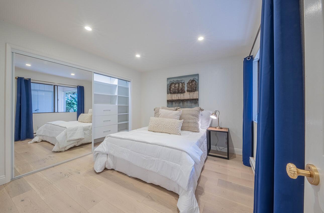 250 Forest Ridge Road, Unit 27 Monterey, CA 93940 - Photo 30 of 38 a spacious bedroom with a bed and a large mirror