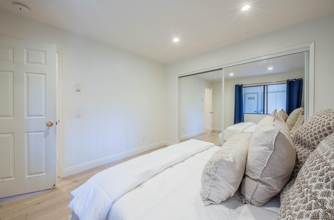 250 Forest Ridge Road, Unit 27 Monterey, CA 93940 - Photo 32 of 38 a bedroom with a bed and a painting