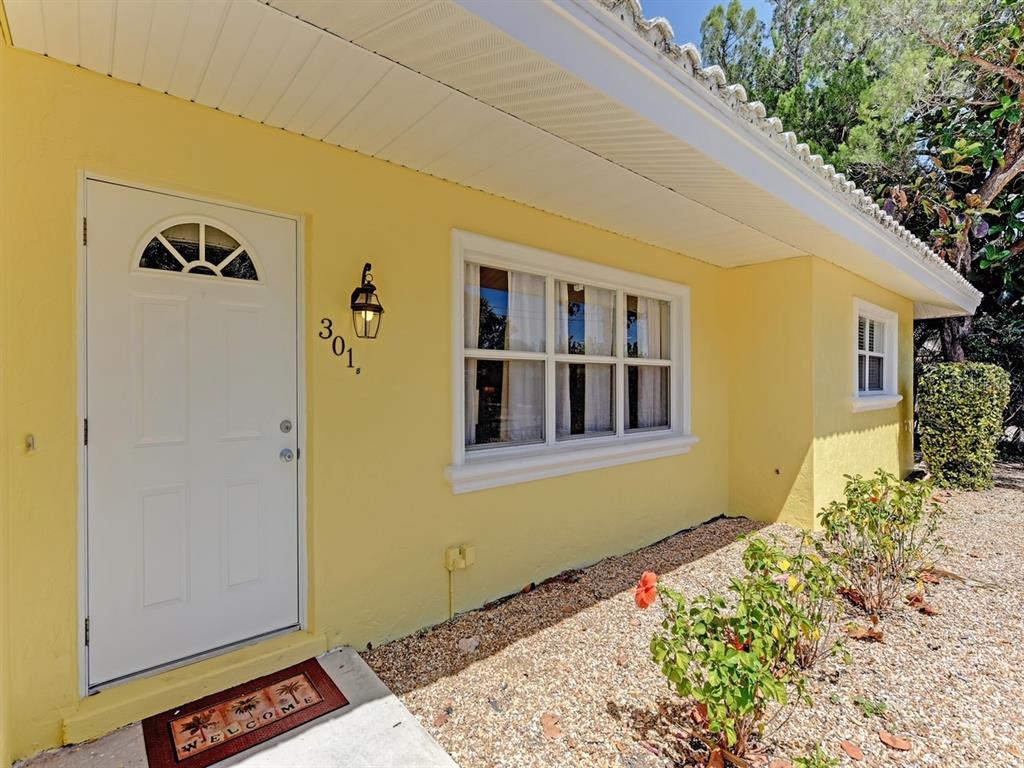 301 Avenida Madera, Unit B Sarasota, FL 34242 - Photo 1 of 18 a front view of a house with a yard