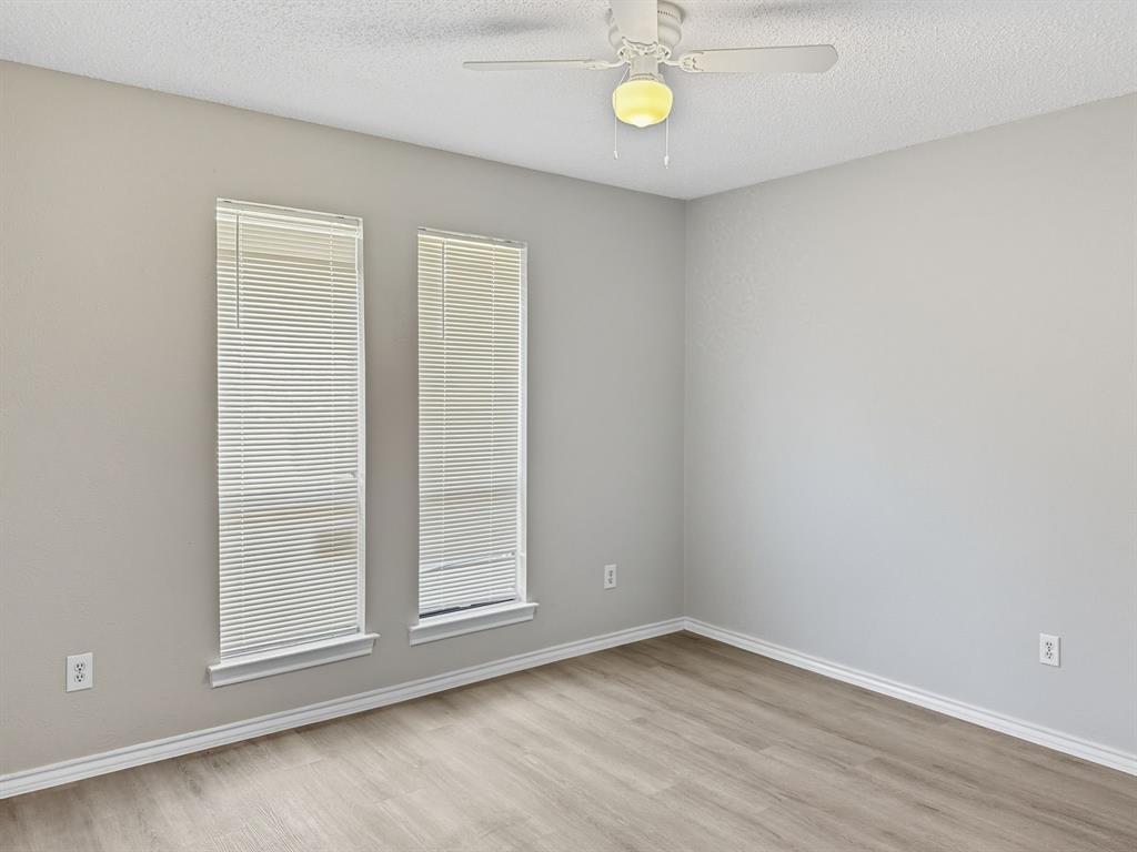 2308 Winterstone Drive Plano, TX 75023 - Photo 11 of 16 a view of an empty room with a window and wooden floor