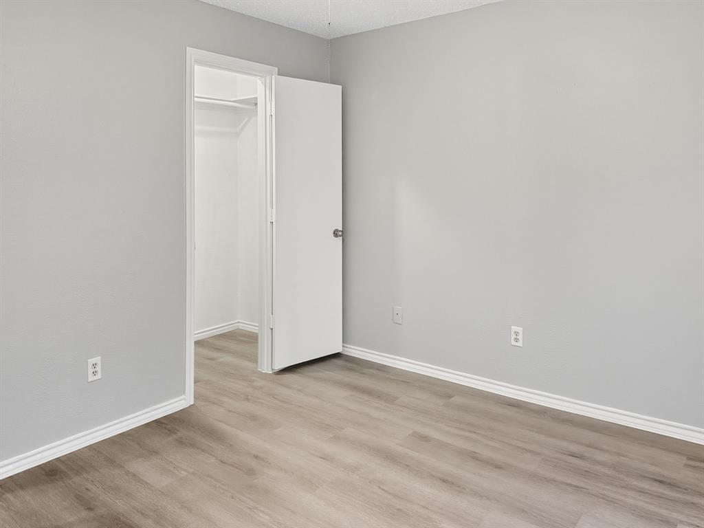 2308 Winterstone Drive Plano, TX 75023 - Photo 12 of 16 a view of an empty room with wooden floor