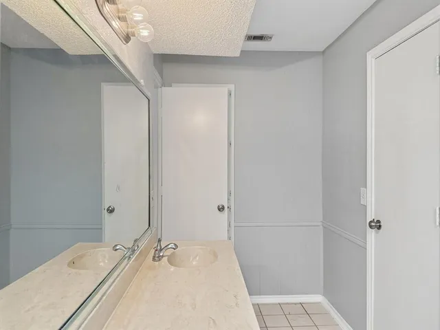 a bathroom with a sink and shower