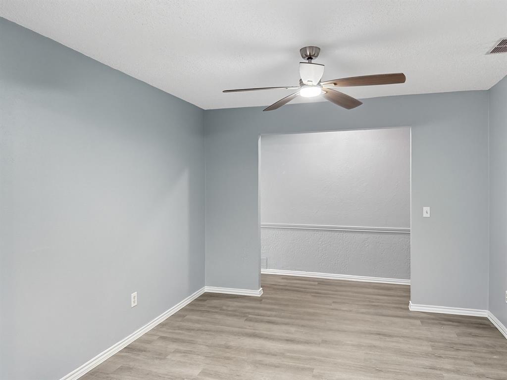 2308 Winterstone Drive Plano, TX 75023 - Photo 7 of 16 a view of an empty room with wooden floor
