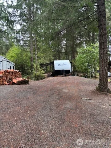 a view of a house with a truck parked next to a road
