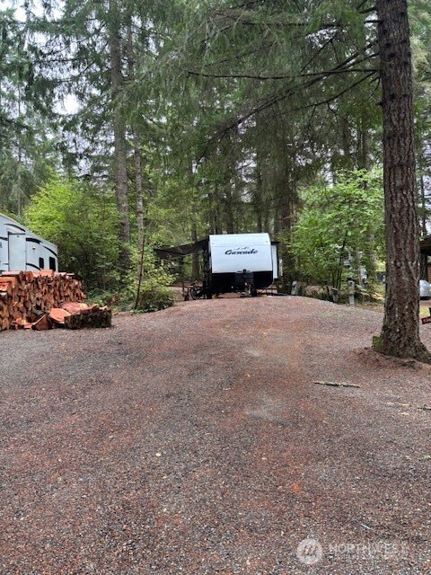 a view of a house with a truck parked next to a road