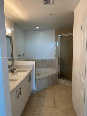a bathroom with a granite countertop sink a toilet and shower