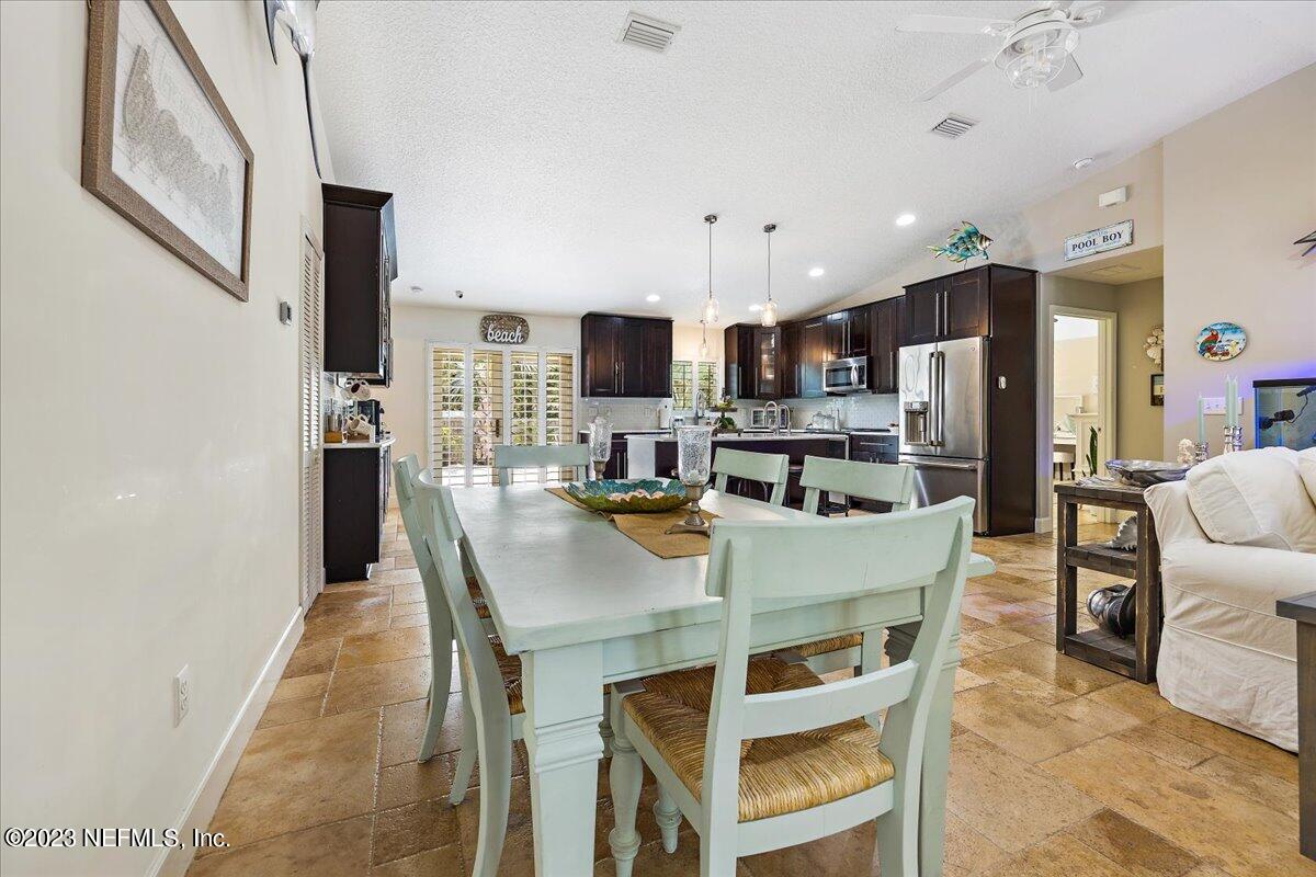 313 Eleventh Street St. Augustine, FL 32084 - Photo 11 of 35 a large kitchen with dining room and wooden floor