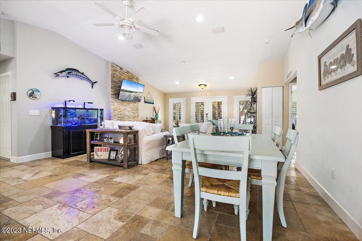 313 Eleventh Street St. Augustine, FL 32084 - Photo 12 of 35 a dining room with furniture and a chandelier