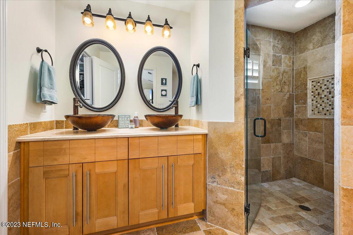 313 Eleventh Street St. Augustine, FL 32084 - Photo 19 of 35 a bathroom with a sink and a mirror