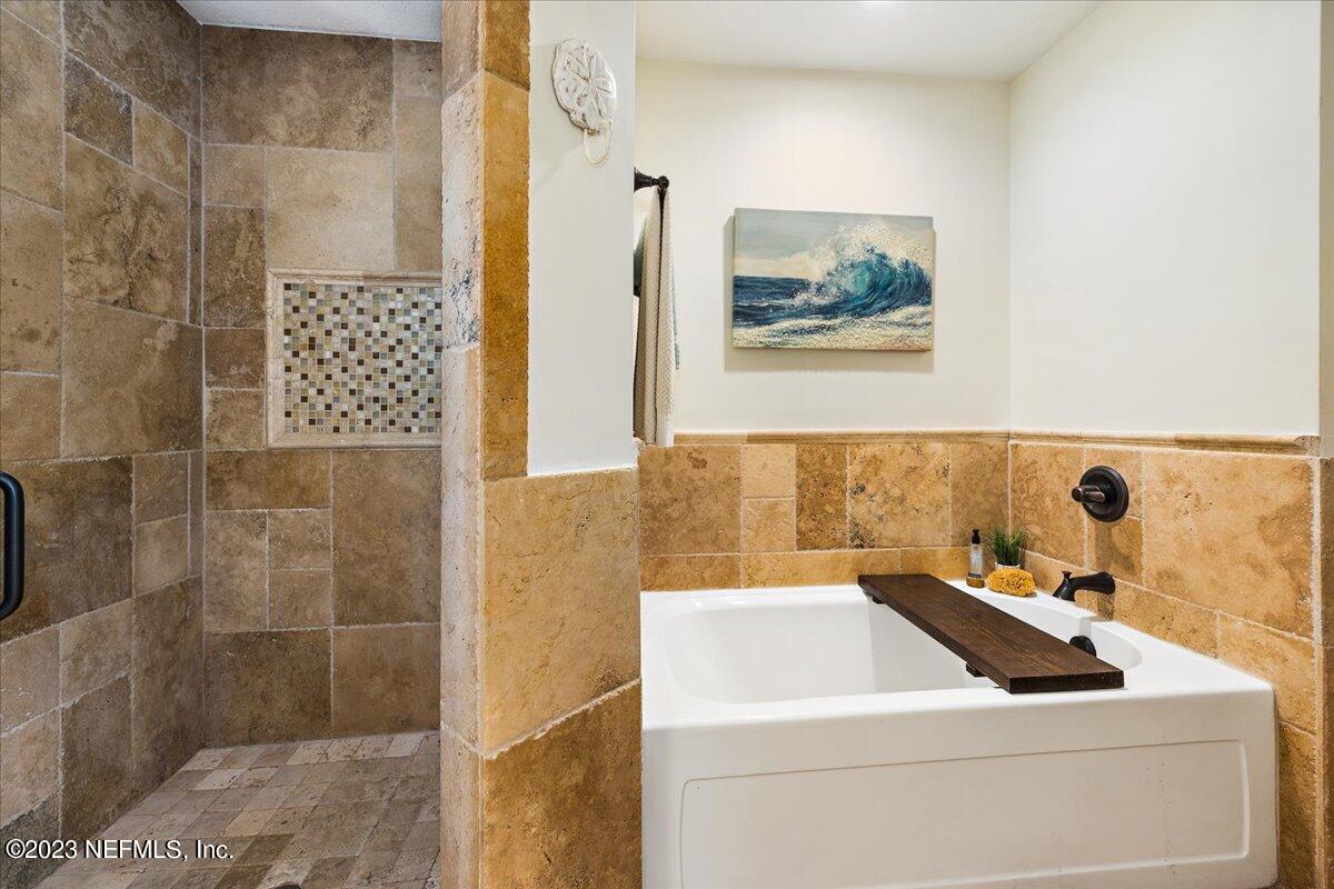 313 Eleventh Street St. Augustine, FL 32084 - Photo 20 of 35 a bathroom with a sink and a shower