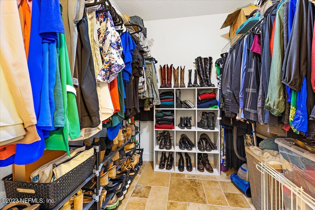 313 Eleventh Street St. Augustine, FL 32084 - Photo 21 of 35 a view of walk in closet with clothes and shoes