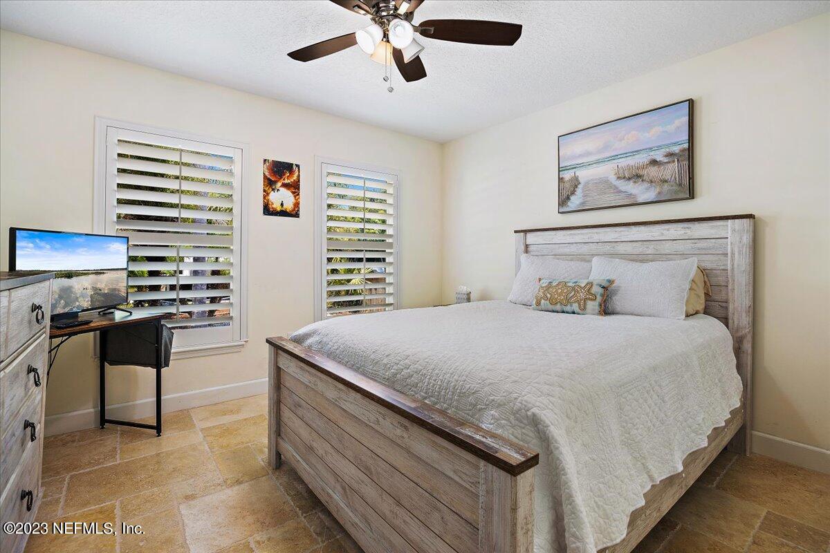 313 Eleventh Street St. Augustine, FL 32084 - Photo 23 of 35 a bedroom with a bed and a desk