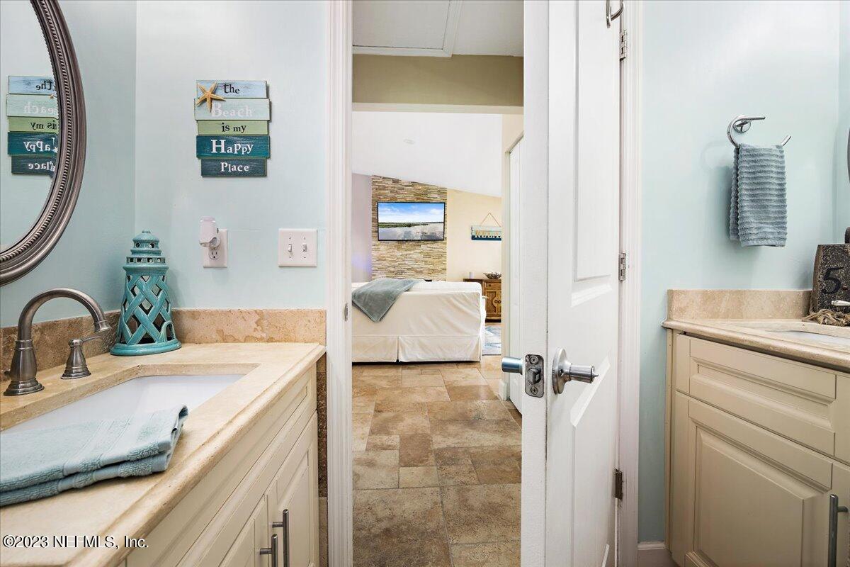 313 Eleventh Street St. Augustine, FL 32084 - Photo 25 of 35 a bathroom with a double vanity sink mirror and shower