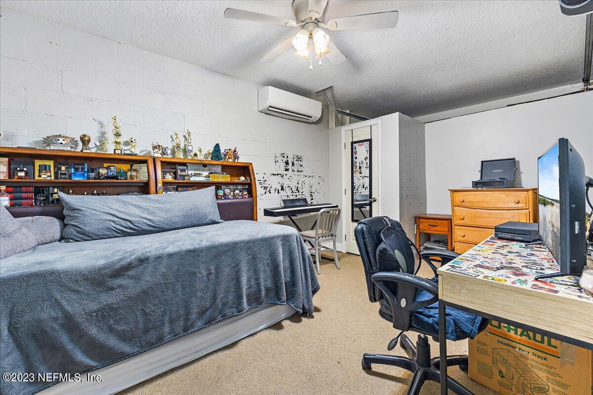 313 Eleventh Street St. Augustine, FL 32084 - Photo 27 of 35 a bedroom with furniture and a window