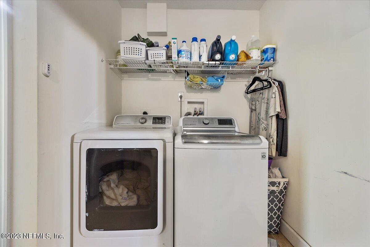 313 Eleventh Street St. Augustine, FL 32084 - Photo 29 of 35 a kitchen with a refrigerator and a stove